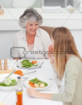 Woman talking with her mother at the table