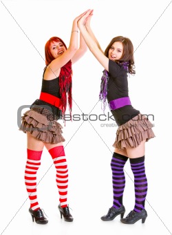 Two young girlfriends clapping hands
