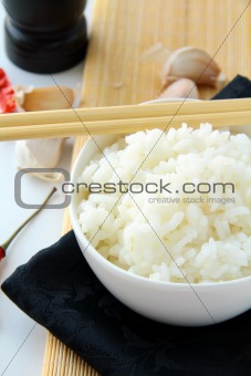 bowl of white fluffy rice with chopsticks