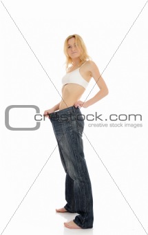 Slim woman in oversized big pants lost her weight. isolated
