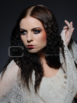 Gothic female portrait with creative make-up and white pure skin