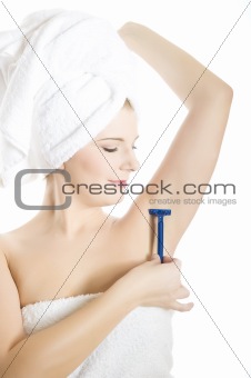 Young beautiful woman shaving