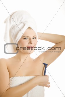 pretty woman shaving her armpit