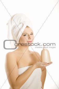 pretty woman with body lotion in bath towel