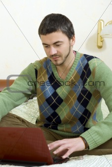 Picture of young handsome man working online from his house
