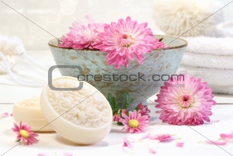 Spa scene with pink  flowers in water 