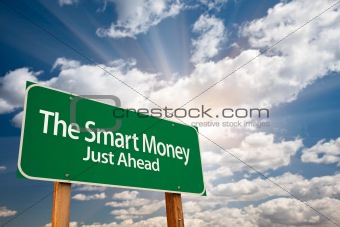 The Smart Money Green Road Sign with Dramatic Clouds, Sun Rays and Sky.
