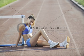 happy young woman on athletic race track
