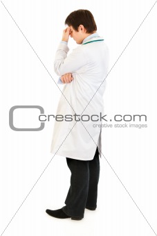 Stressed medical doctor holding fingers at noseband
