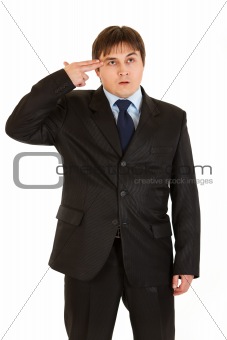Stressed modern businessman with gun shaped hand
