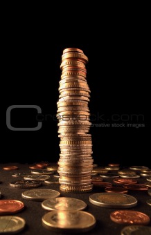 A column of coins surrounded by changes