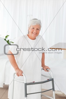 Senior woman looking at the camera with her zimmer frame
