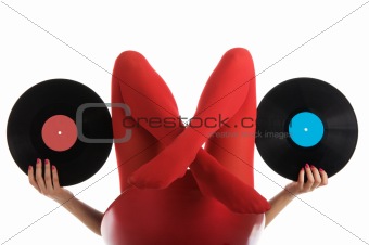 Female feet in red stockings with vinyl record