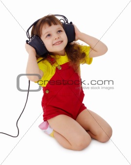 Little girl listens to music