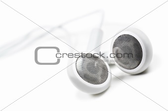 White earphones on a white background with space for text