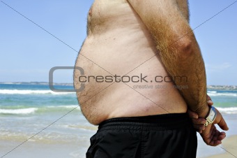 Fat man on the beach