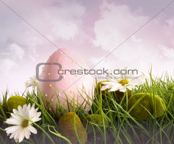 Large pink easter with flowers in tall grass