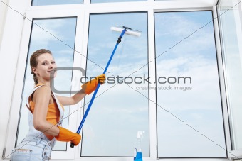 Nice girl washing a window