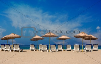 Sun loungers on a deserted beach