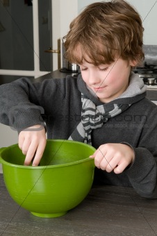 Boy making the dough for the cakes
