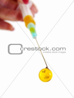 Disposable syringe with a yellow medicine in women's hands, isolated 