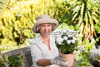 Senior woman with flowers in her garden