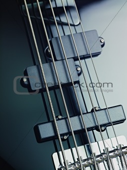 details of electric bass, pickups and cords