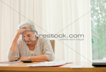 Retired woman calculating her domestic bills