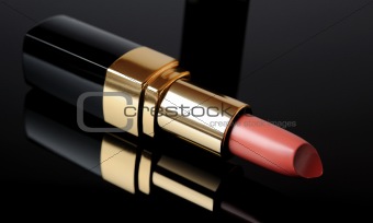 Luxury pink lipstick on black background. make-up