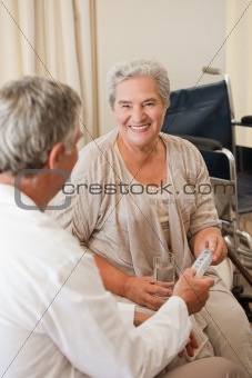 Doctor giving pills to his patient