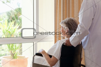 Doctor with his patient looking out the window
