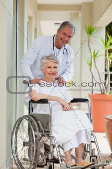 Doctor with his patient looking at the camera