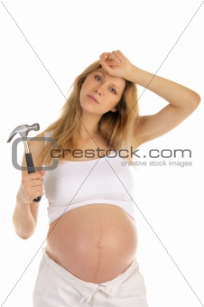 tired pregnant woman with a hammer