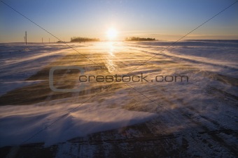 Ice on road at sunrise.