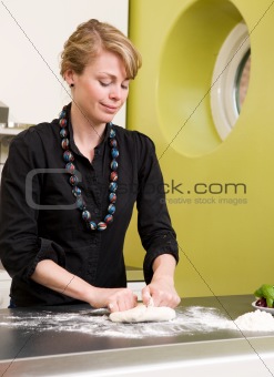Young Woman Happily Making Pizza Dough