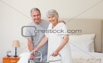 Man helping his wife to walk