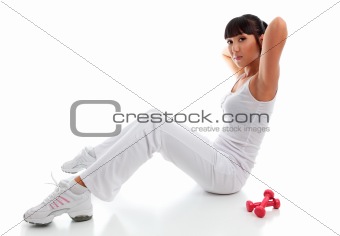Beautiful young woman exercising sit ups