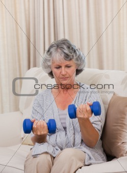 Woman doing her exercises on her sofa