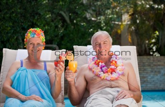 Happy senior couple drinking cocktails