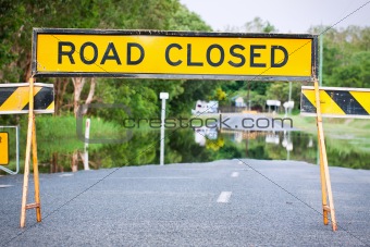 Road closed traffic sign on a flooded road