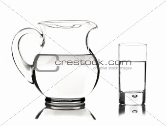 Glass and glass pitcher on white background