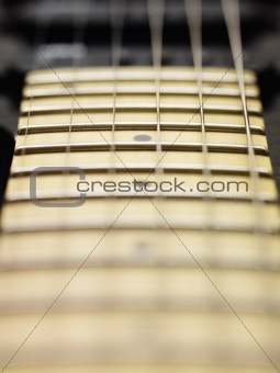detail of electric guitar cords and frets