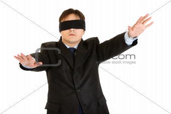 Disoriented businessman with blindfold covering his eyes
