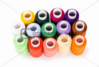Spools multi-colored threads standing group isolated on a white background