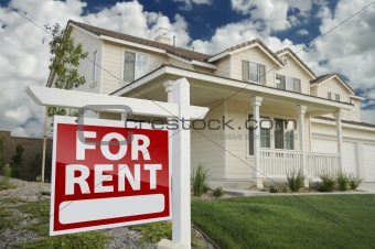 Right Facing Red For Rent Real Estate Sign in Front of Beautiful House.
