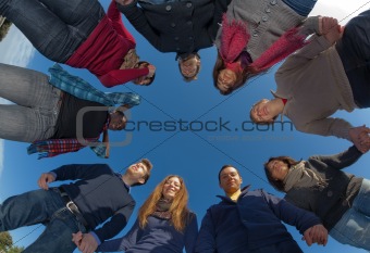 Multiracial People Holding Hands in a Circle, Low Angle View