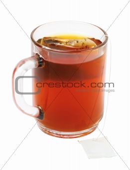 Close-up of tea bag and cup of tea isolated on white background