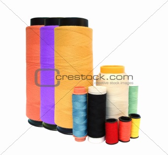 Coloured bobbins of threads isolated on white background