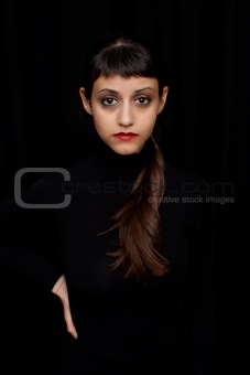 Portrait of a beautiful young woman, on black background