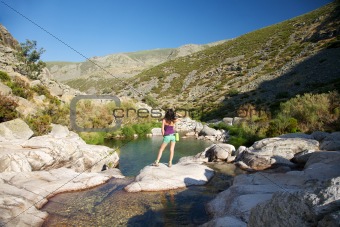 sensual woman on a rock watching river